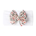Détail du bandeau bébé blanc élastique orné d'un grand nœud à motif floral délicat - Blanc