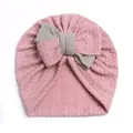 Detail der Baby-Turbanmütze mit grauer Schleife und rosa Zopfstrickmuster aus Baumwolle - Rosa