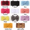 Flat lay of soft waffle knit baby headbands with large bows in eleven vibrant colors - 11 Colors Assorted