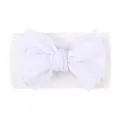 Detailed view of white nylon baby headband with large textured waffle bow detail - White