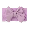 Detail of purple waffle texture nylon baby headband featuring a large soft bow decoration - Purple