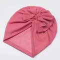 Close-up of baby mesh turban hat in dark pink with a large bow and white stitching - Dark Mauve