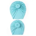 Close-up of two light blue knit baby turban hats with stylish donut knot details - Blue