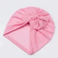 Detail of pink baby turban hat showing soft mesh fabric texture and decorative bow - Pink