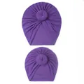 Close-up of matching purple parent-child turban hats with handmade doughnut knot detail - Purple