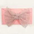 Detail of pink baby headband with a large glitter mesh bow on soft knit fabric - Pink