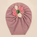 Detailed view of baby turban hat featuring a handcrafted tri-color fabric flower and button - Taro Purple
