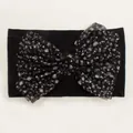 Detail of baby headband featuring large black mesh bow with silver glitter dots - Black