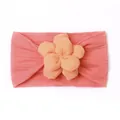 Close-up of pink nylon baby headband showing soft knit texture and 3D floral detail - Watermelon red