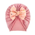Close-up of baby turban hat featuring a large dusty pink bow with gold polka dots decoration - Dusty Pink And Buds