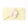 Detail of soft pale yellow ribbed baby headband featuring a delicate cream fabric flower - Beige
