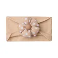 Detail of soft elastic baby headband featuring a pink polka dot flower and fabric texture - Beige Coffee
