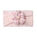 Close-up of pink elastic baby headband with a 3D red polka dot fabric flower detail - Light Pink