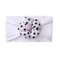 Detail of baby headband with a black and white polka dot flower and purple button - White