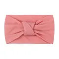 Close-up of soft peach pink knitted baby headband featuring a textured knotted design - Dark Mauve