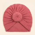 Pink donut baby turban hat made of soft waffle fabric with elastic ribbed knit texture - Dark Mauve