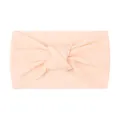 Close-up of soft knitted nylon baby headband with knot detail in blush pink color - Nude Pink