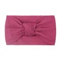 Macro detail of elastic magenta nylon baby headband with a wide twisted knot design - Deep Purple