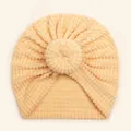 Detail of soft peach waffle knit fabric and donut knot on infant turban hat - Beige