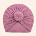 Close-up of soft purple baby donut turban hat featuring waffle texture fabric and knotted design - Purple