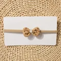Close-up of baby elastic headband with beige floral bow knot on natural straw mat - Dark Beige Floral Bow