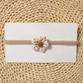 Detail of baby elastic headband with polka dot fabric flower on display card - Light Khaki Polka Dot Flower