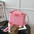 Pink lychee texture leather handbag with gold round metal buckle and top handle - Pink