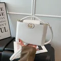 Elegant white cross-grain leather bucket bag with gold magnetic buckle and top handle - White