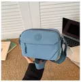 Dettaglio borsa a tracolla in nylon blu con logo del marchio e tracolla in tessuto - Blu