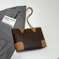 Detailed view of dark brown pebbled leather tote bag with cognac contrast trim and handles - Brown