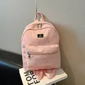 Pink minimalist backpack with silver star print and front zipper pocket for daily commute - Pink