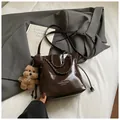 Deep brown glossy bucket bag with metal chain handle and cute teddy bear charm - With Pendant / Brown