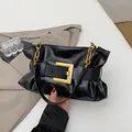 Chic black pleated cloud bag with a large gold buckle and metal chain strap - Black