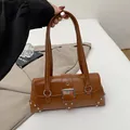 Vintage brown leather shoulder bag with metallic buckle and silver rivets detail - Brown