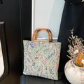 Floral canvas tote bag with colorful embroidery and natural bamboo top handles - Green Flower