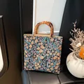 Floral canvas tote bag with bamboo handles featuring vintage orange and pink prints - Black
