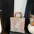 Floral embroidered canvas tote bag featuring natural bamboo handles in a retro style - Purple Flower