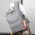 Grey casual backpack with USB charging port and stylish orange zipper details - Gray