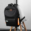 Black casual backpack with orange zipper accents and external USB charging port - Black