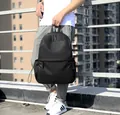 Detail of a matte black outdoor backpack featuring dual zippers and drawstring side pockets - Black