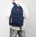 Waterproof navy blue oxford backpack with orange zipper pulls for casual outdoor travel - Blue
