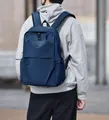 Navy blue business laptop backpack with USB charging port shown on a male model outdoors - Blue