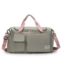 Macro view of gray nylon travel bag with pink straps and multi-pocket front detail - Green