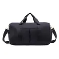 Detail of black nylon sports bag featuring gold hardware and detachable shoulder strap - Black