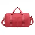 Detail of red sports duffel bag showing independent side shoe compartment and waterproof fabric - Red