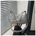 Silver crescent underarm bag with geometric texture and star-heart chain charms - Silver