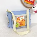 Detail of light blue ita bag showing transparent front pocket and multi-zippered design - Blue