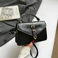 Classic black flap crossbody bag with gold U-shaped metal buckle and top handle - Black