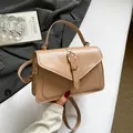 Minimalist beige crossbody bag with top handle and metal buckle detailing - Khaki