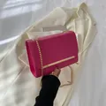 Chic magenta crossbody bag with gold chain strap and elegant metal bar detail - Rose Pink